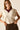 Top beige con volantes en las mangas