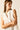 Blusa blanca sin mangas con volantes