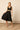 Mono midi negro con escote cruzado
