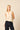 Top sin mangas beige con escote pico
