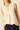 Top sin mangas beige con escote pico