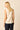 Top sin mangas beige con escote pico