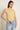 Top lino sin mangas cuello volante amarillo