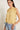 Top lino sin mangas cuello volante amarillo