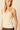 Top de punto beige con escote pico