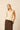 Top de punto beige con escote pico
